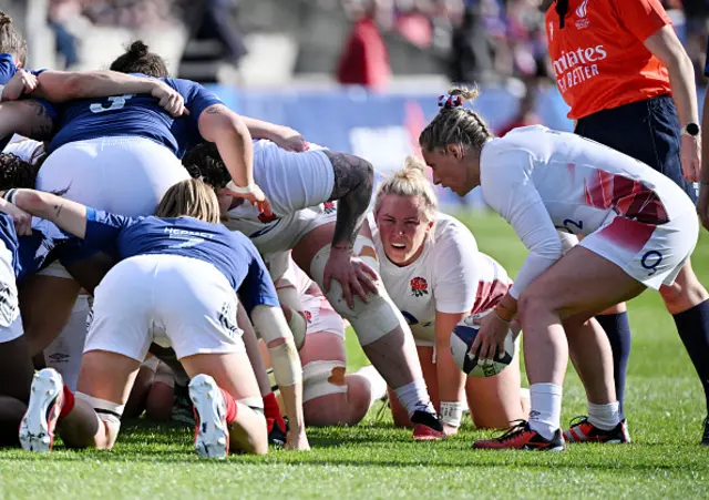 Marlie Packer of England looks on as Natasha Hunt prepares to feed the ball into a scrum