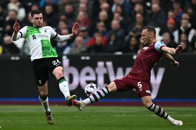 Andrew Robertson vies with West Ham United's Czech defender Vladimir Coufal