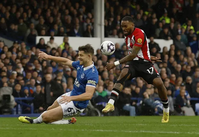 Tarkowski blocks a shot from Toney on the edge of the box