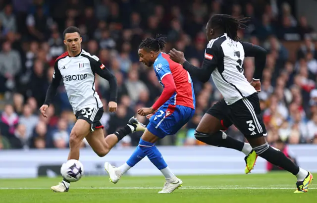 Michael Olise of Crystal Palace shoots under pressure from Calvin Bassey