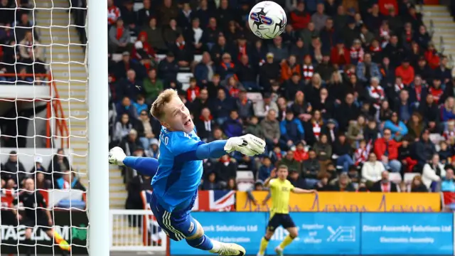 Exeter City's Viljami Sinisalo makes a diving save