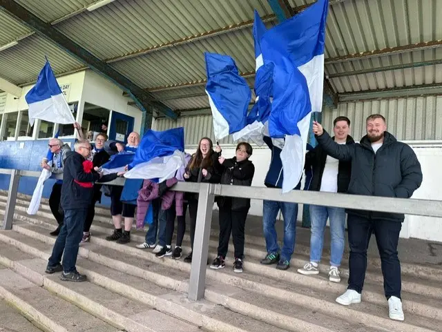 Barrow fans wave flags