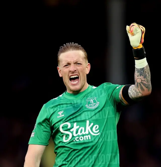 Pickford fist pumps after Everton's victory is confirmed.