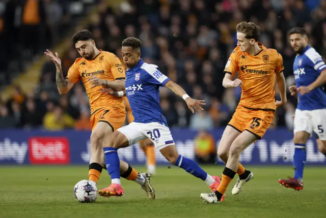 Ipswich Town's Omari Hutchinson (centre) battles for the ball with Hull City's Ozan Tufan (left) and Tyler Morton (right)