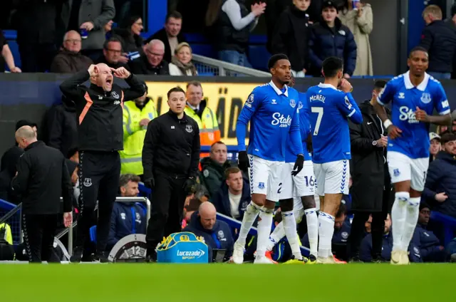 Dyche bellows at his players from the touchline as some take a drinks break