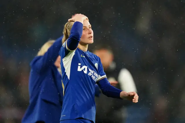 Aggie Beever-Jones holds her hand to her head