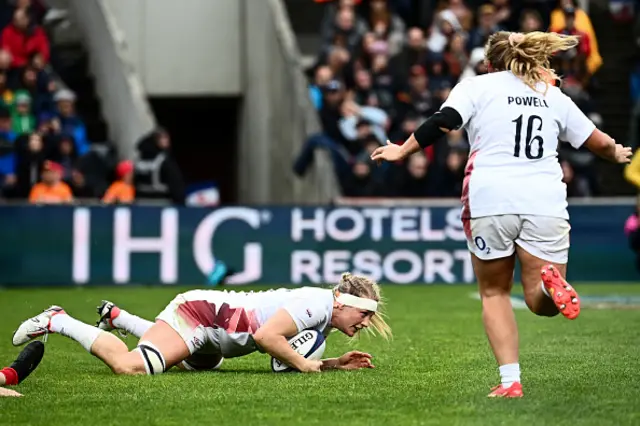 Marine Menager (C) celebrates after scoring the team's third try