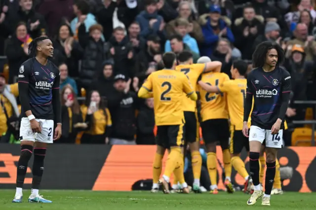 Luton players stand desconsolate after a Wolves goal