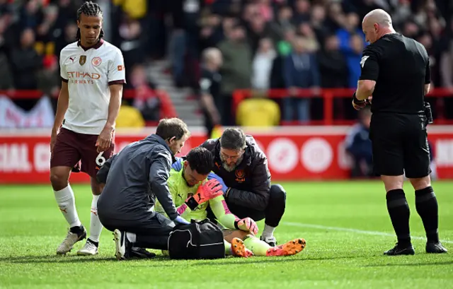 Ederson of Manchester City receives medical treatment