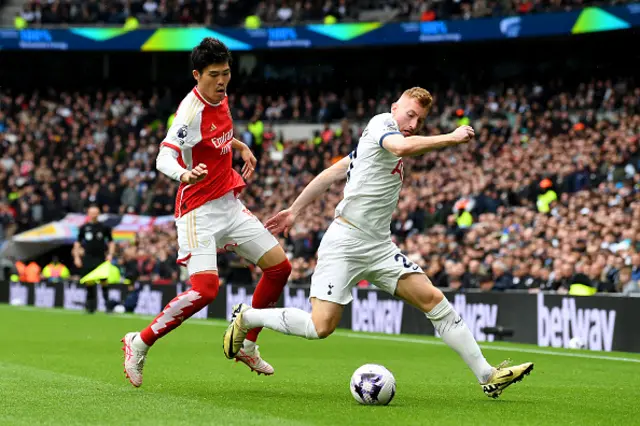 Takehiro Tomiyasu of Arsenal battles for possession with Dejan Kulusevski