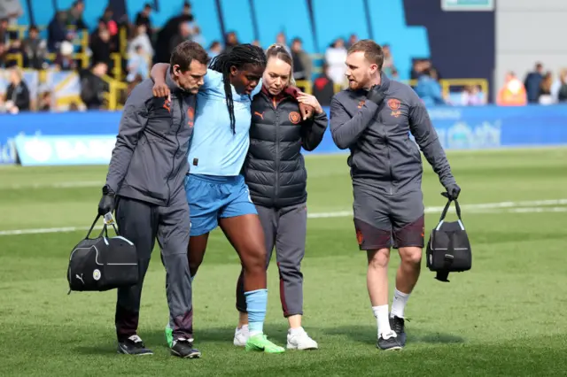 Shaw is helped off the pitch after sustaining an injury