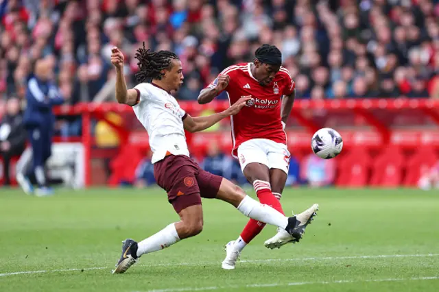 Nathan Ake of Manchester City tackles Anthony Elanga