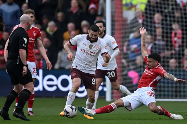 Mateo Kovacic (C) is tackled by Nottingham Forest's English midfielder #10 Morgan Gibbs-White