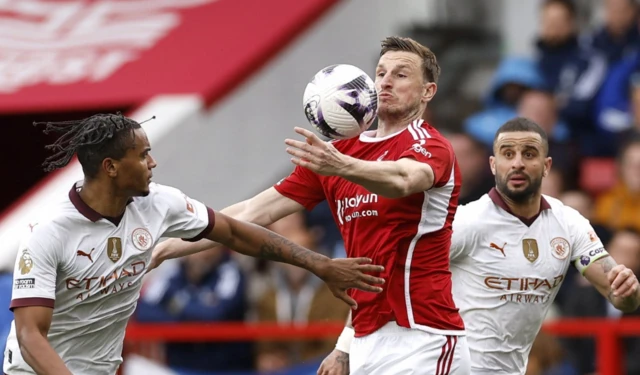 Nottingham Forest's Chris Wood in action with Manchester City's Kyle Walker and Manuel Akanj