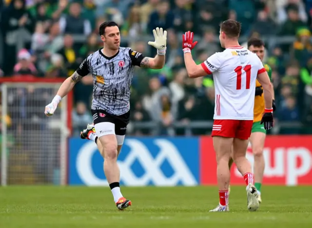 Tyrone keeper Niall Morgan is congratulated by Kieran McGeary after scoring a point