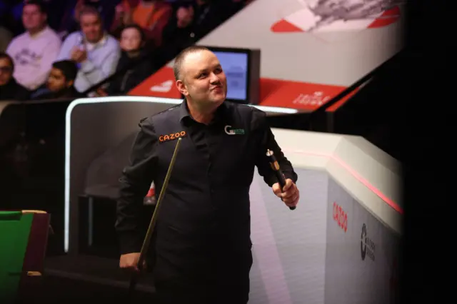 Stephen Maguire walks out of the arena with a smile on his face after beating Shaun Murphy