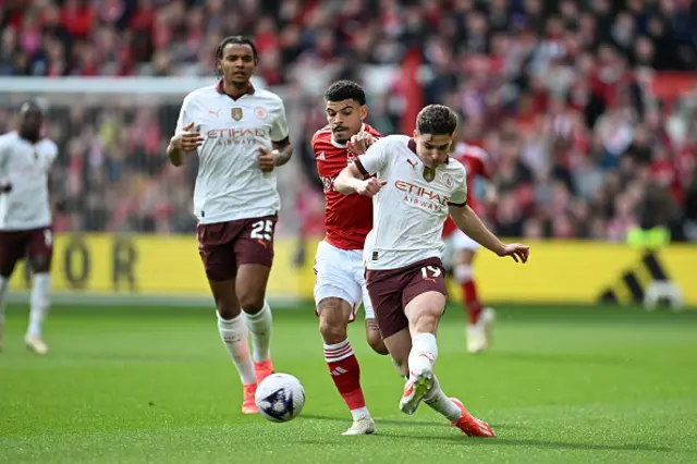 Morgan Gibbs-White of Nottingham Forest battles for possession with Julian Alvarez