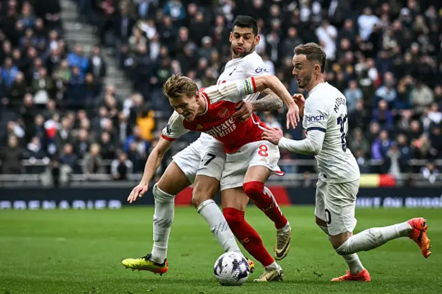 Martin Odegaard is brought down by James Maddison