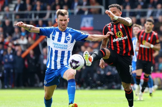 Justin Kluivert in action with Brighton & Hove Albion's Pascal Gross