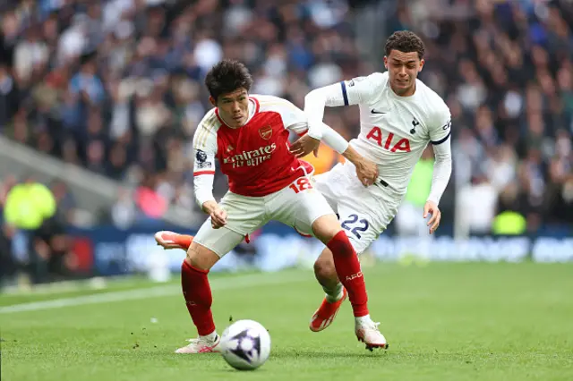 Takehiro Tomiyasu of Arsenal is challenged by Brennan Johnson