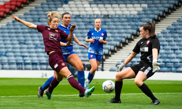 Kate Mooney scores to give Hearts the lead against Spartans