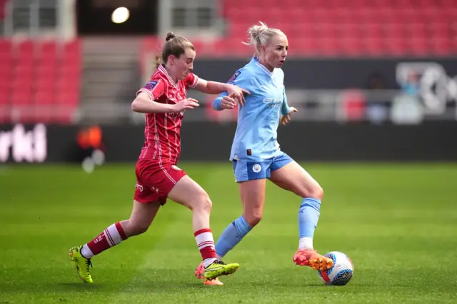 Bristol City's Carrie Jones (left) and Manchester City's John Stones battle for the ball during the Barclays Women's Super League match at Ashton Gate, Bristol.