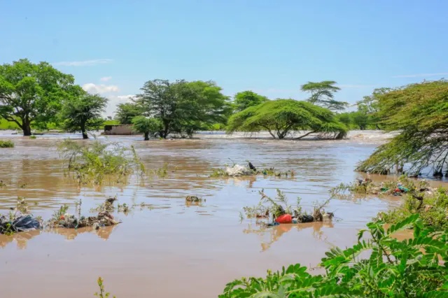 The Athi River bursts its banks during the heavy rains on April 23, 2024 in Machakos, Kenya. Parts of Kenya have experienced heavy flooding since mid-March, with more than 11,000 households displaced, widespread damage to agricultural land, and thousands of livestock lost.