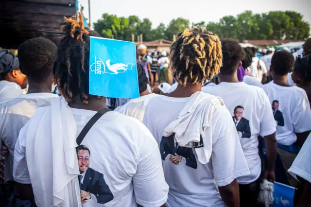 Supporters of the Union for the Republic (UNIR) wear t-shirts with the portrait of Togolese President Faure Gnassingbe on it during a campaign meeting in Lome on April 27, 2024