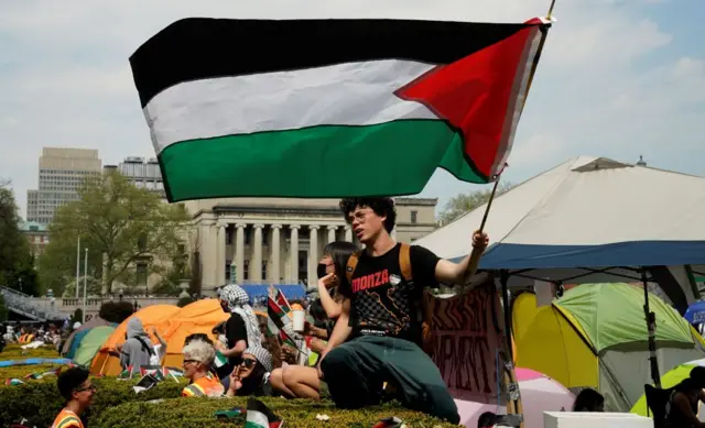 A protestor waves a Palestinian flag on the West Lawn of Columbia University on April 29, 2024 in New York.