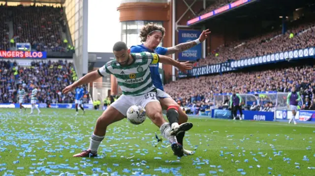 Celtic and Rangers players battle for the ball