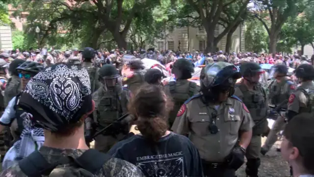 Riot-gear equipped police entering the protest site at UT-Austin