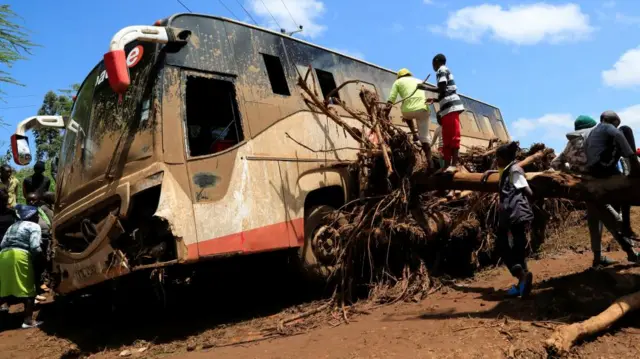 A view shows a damaged passenger bus stuck on a fallen tree after heavy flash floods wiped out several homes when a dam burst, following heavy rains in Kamuchiri village of Mai Mahiu, Nakuru County, Kenya April 29, 2024