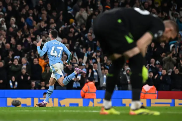 Foden cleebrates as Olsen stands on his haunches
