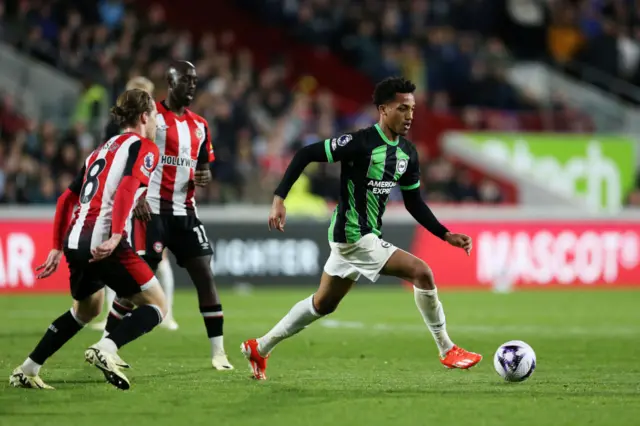 Gomes runs across the Brentford midfield