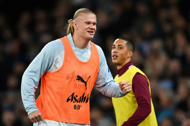 Haaland runs to warm up as Tielemans watches on