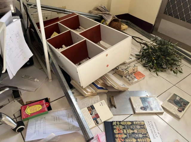 The earthquake caused furniture to fall and loose items to be scattered over the floor