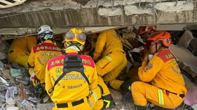 Kaohsiung Fire Department staff search inside a building for rescue operation after the powerful earthquake struck off Taiwan's eastern coast