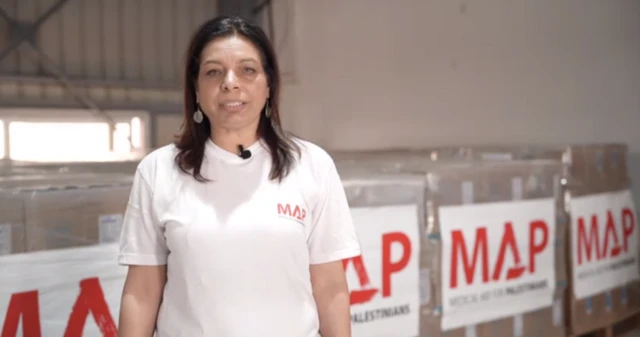 A woman standing in front of boxes