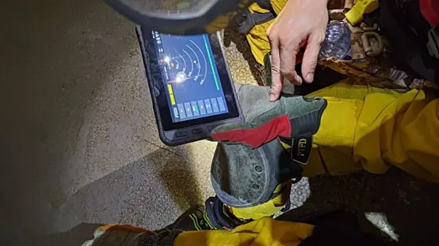 Rescue workers use equipment to search for survivors and anticipate aftershocks