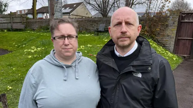 Man and woman standing in garden