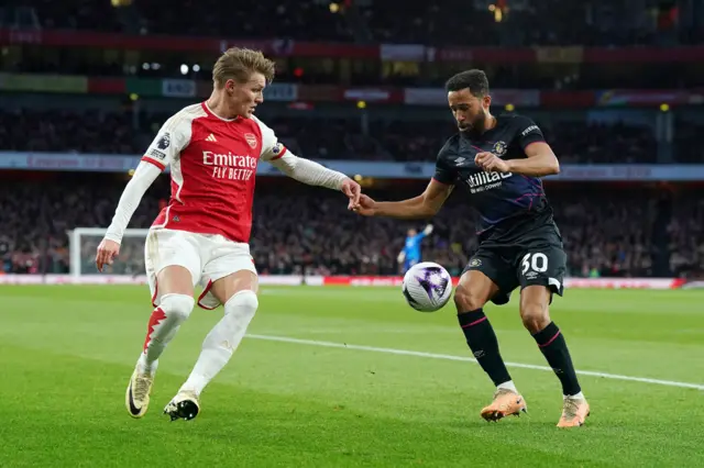 Townsend looks to dribble past Odegaard