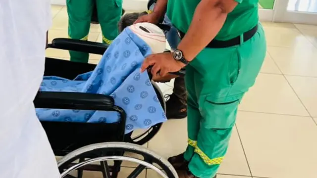 The injured girl is transported by wheelchair before flying from South Africa to Botswana