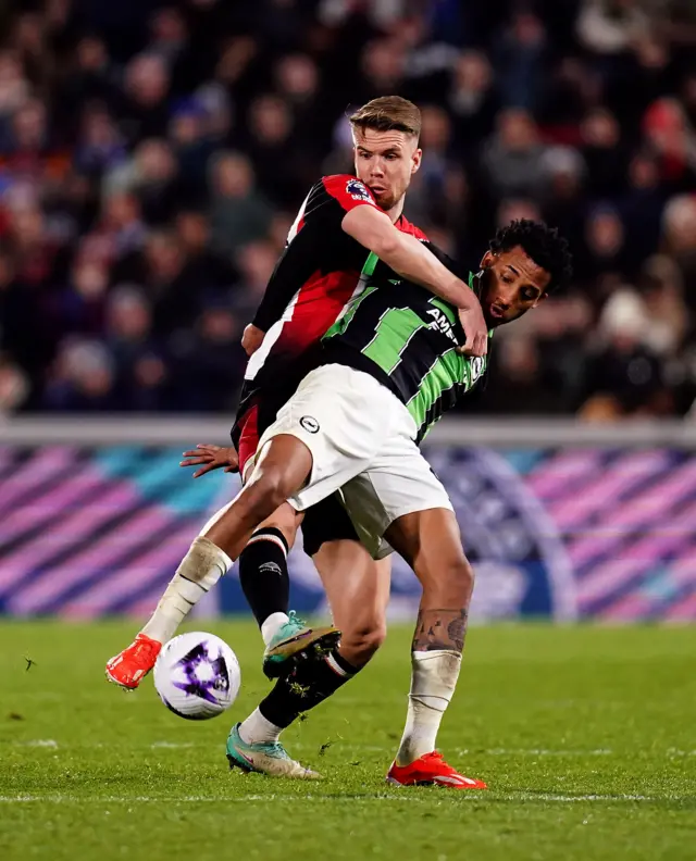 Brentford and Brighton players tussle for the ball