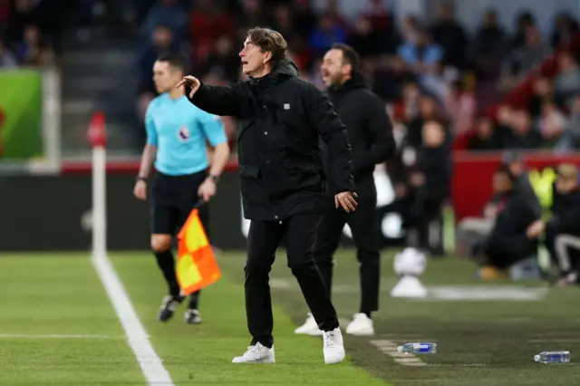 Frank directs players from the touchline