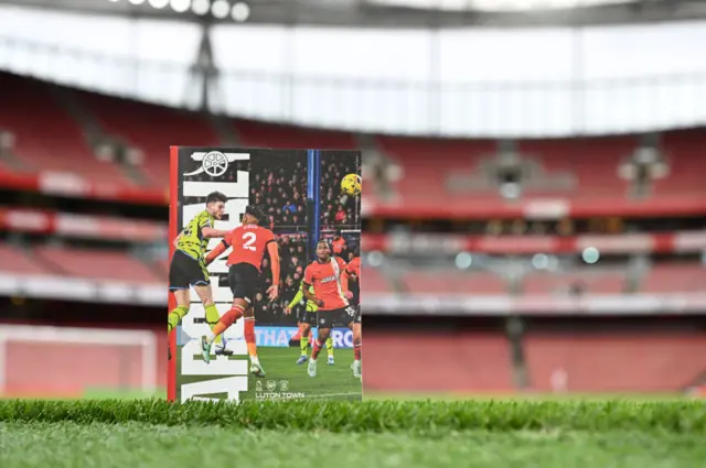 Match programme stands on the side of the Emirates pitch