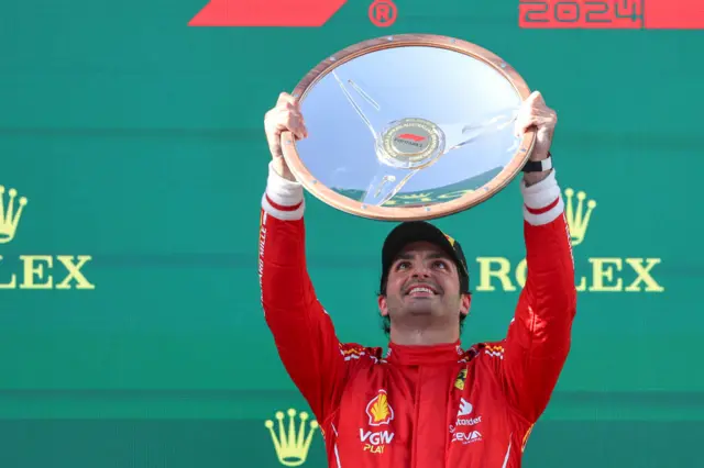 Carlos Sainz lifts the Australian Grand Prix trophy