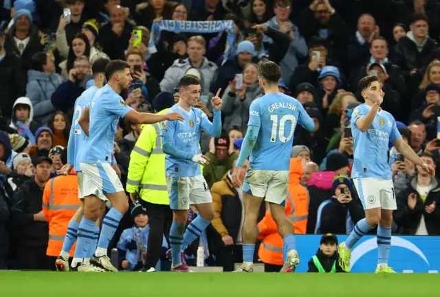 Foden is mobbed by teammates after his second goal