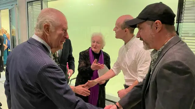 King Charles shakes hands with patients during a visit to the University College Hospital Macmillan Cancer Centre