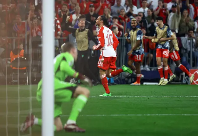 Sane runs to celebrate as Lunin sits on the floor in his net