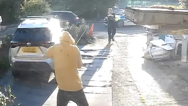 Attacker facing the police officer, holding knife